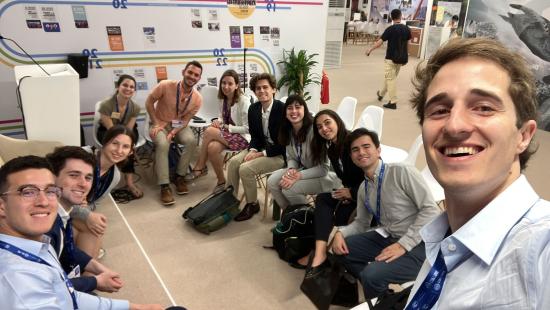 A large group of Yale students during a COP28 daily debrief session