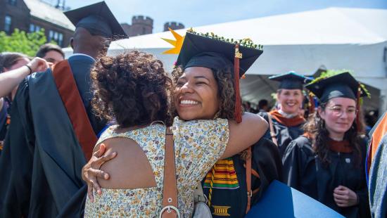 Class of 2022 graduate hugging a family member