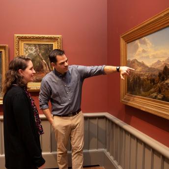 Duguid and Brodersen discussing a landscape painting