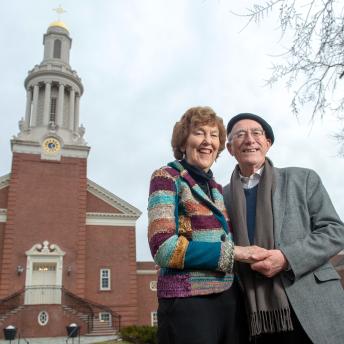 Mary Evelyn Tucker and John Grim standing together outside the Yale Divinity School