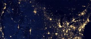 PhD — satellite image of U.S. at night showing illuminated cities