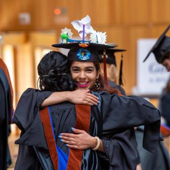 Graduates hugging before YSE commencement ceremonies