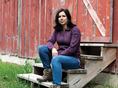 Potrait of Chelsea Chandler sitting on wodden steps to a red barn