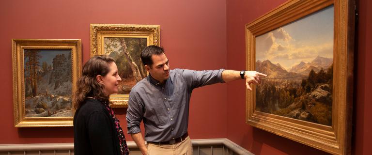 Duguid and Brodersen discussing a landscape painting