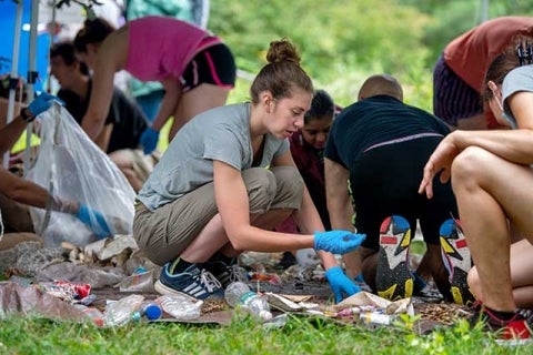 Students sorting material found in a park