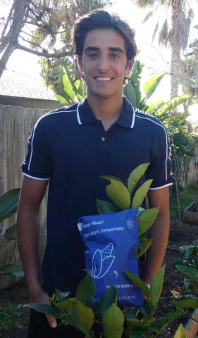 Shervin Dehmoubed holding a compostable shipping bag