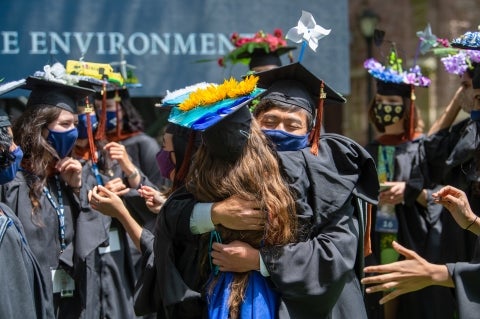 Masked students embracing at YSE Commencement