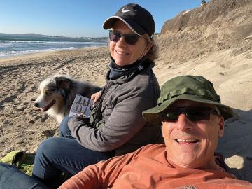 Class of 1984 grads Chris Stecko and April Grimm with their dog, Mica, in Half Moon Bay, California.
